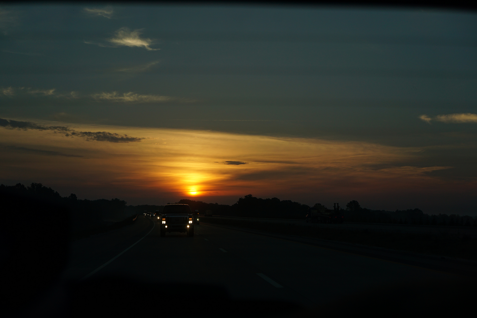 Sunrise from the back window of the car, southern Indiana / Darker than Green