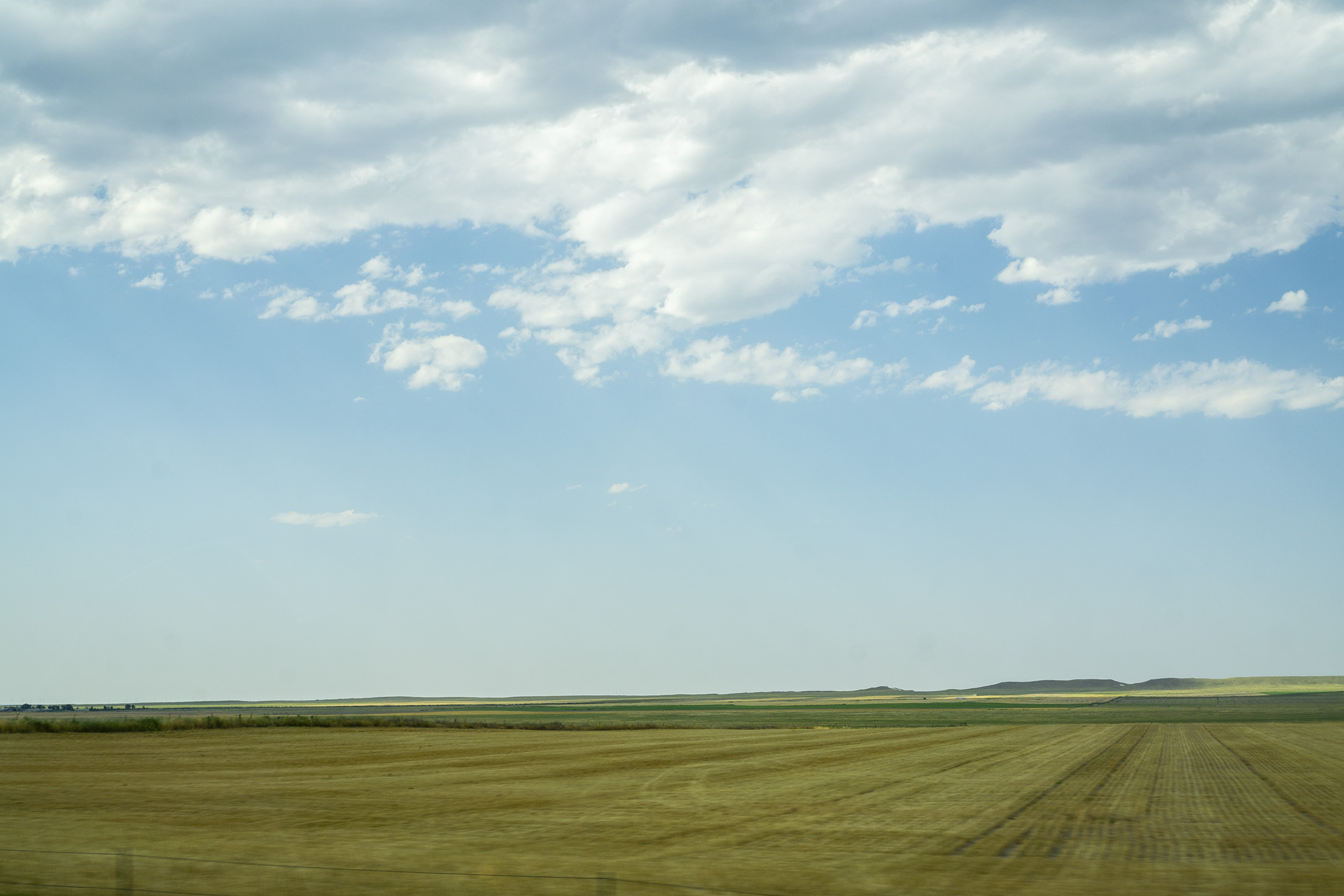 Farmland and open sky somewhere in Iowa / Darker than Green