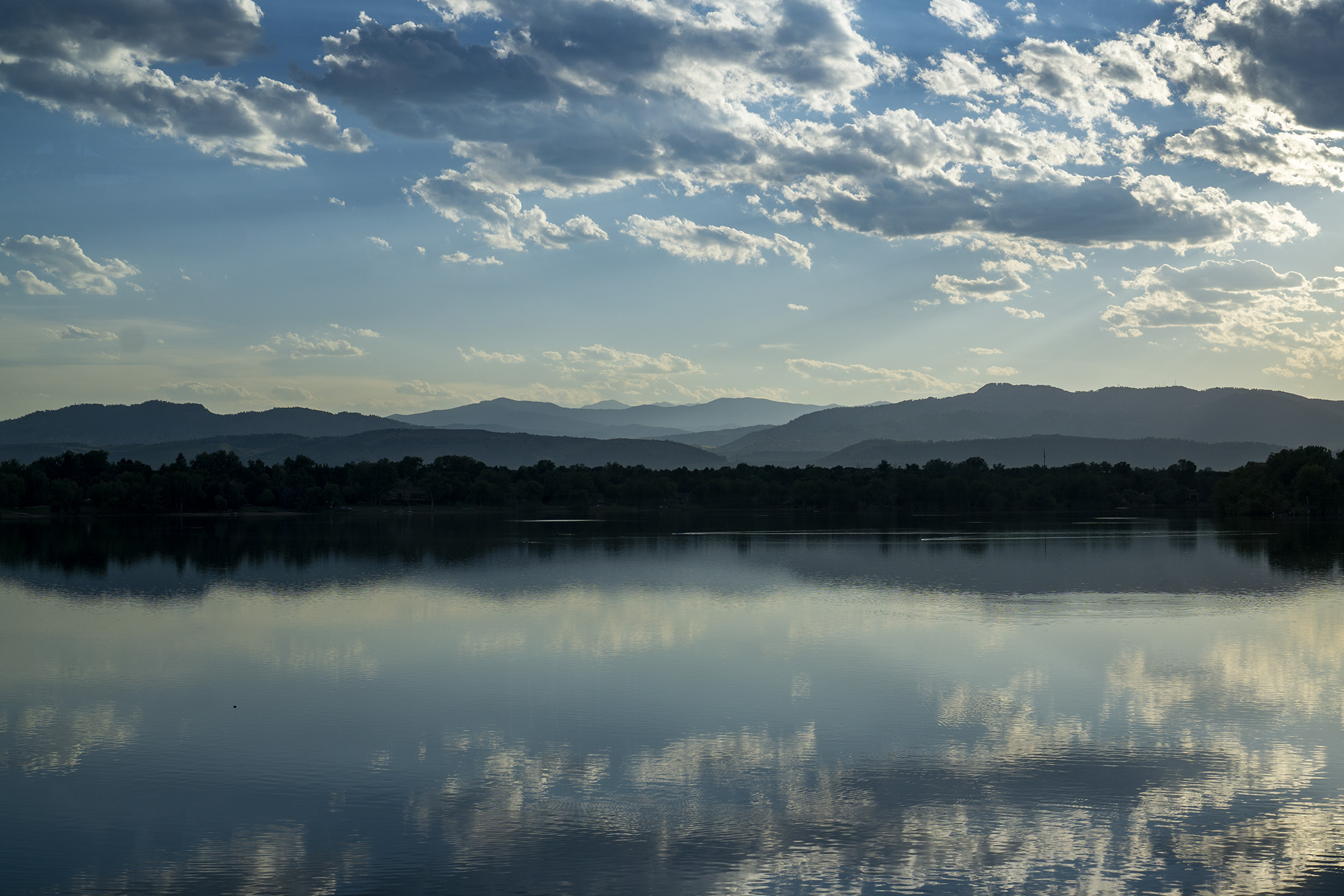 View toward Horsetooth Rock across a lake in early evening, Fort Collins, Colorado / Darker than Green